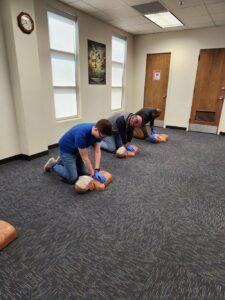 The goal of the Adult First Aid, CPR & AED training program is for participants to gain or improve knowledge and skill proficiency.  This program incorporates the latest science and teaches students to recognize and care for a variety of first aid emergencies such as burns cuts scrapes sudden illnesses head neck back injuries heat and cold emergencies and how to respond to breathing and cardiac emergencies and more.